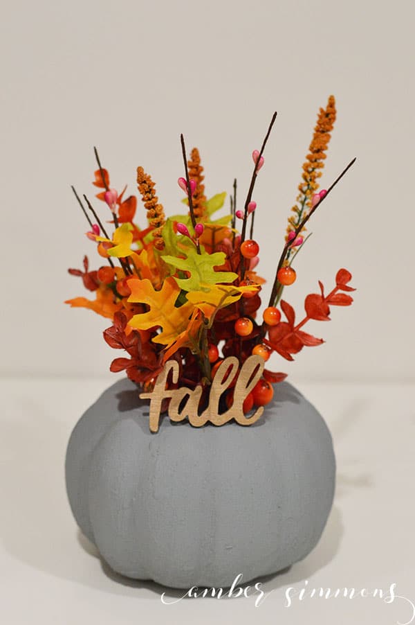 This easy beautiful modern faux cement pumpkin planter will raise your autumn decor game with its industrial vibe.