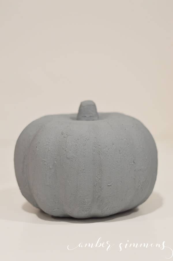 This easy beautiful modern faux cement pumpkin planter will raise your autumn decor game with its industrial vibe.